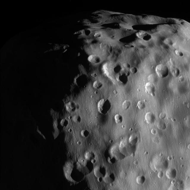 This zoomed-in view of Epimetheus, one of the highest resolution ever taken, shows a surface covered in craters, vivid reminders of the hazards of space. Epimetheus (70 miles or 113 kilometers across) is too small for its gravity to hold onto an atmosphere. It is also too small to be geologically active. There is therefore no way to erase the scars from meteor impacts, except for the generation of new impact craters on top of old ones. This view looks toward anti-Saturn side of Epimetheus. North on Epimetheus is up and rotated 32 degrees to the right. The image was taken with the Cassini spacecraft narrow-angle camera on Feb. 21, 2017 using a spectral filter which preferentially admits wavelengths of near-infrared light centered at 939 nanometers. The view was acquired at a distance of approximately 9,300 miles (15,000 kilometers) from Epimetheus and at a Sun-Epimetheus-spacecraft, or phase, angle of 71 degrees. Image scale is 290 feet (89 meters) per pixel. https://photojournal.jpl.nasa.gov/catalog/PIA21335