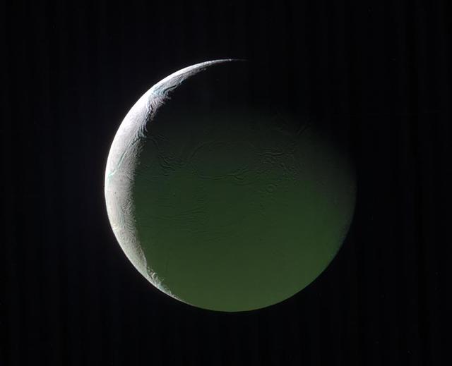 The brightly lit limb of a crescent Enceladus looks ethereal against the blackness of space. The rest of the moon, lit by light reflected from Saturn, presents a ghostly appearance.  Enceladus (313 miles or 504 kilometers across) is back-lit in this image, as is apparent by the thin crescent. However, the Sun-Enceladus-spacecraft (or phase) angle, at 141 degrees, is too low to make the moon's famous plumes easily visible.  This view looks toward the Saturn-facing hemisphere of Enceladus. North on Enceladus is up. The above image is a composite of images taken with the Cassini spacecraft narrow-angle camera on March 29, 2017 using filters that allow infrared, green, and ultraviolet light. The image filter centered on 930 nm (IR) was is red in this image, the image filter centered on the green is green, and the image filter centered on 338 nm (UV) is blue.  The view was obtained at a distance of approximately 110,000 miles (180,000 kilometers) from Enceladus. Image scale is 0.6 miles (1 kilometer) per pixel.  The Cassini spacecraft ended its mission on Sept. 15, 2017.  https://photojournal.jpl.nasa.gov/catalog/PIA21346