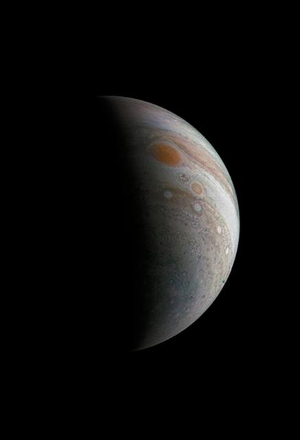 NASA image: Crescent Jupiter with the Great Red Spot