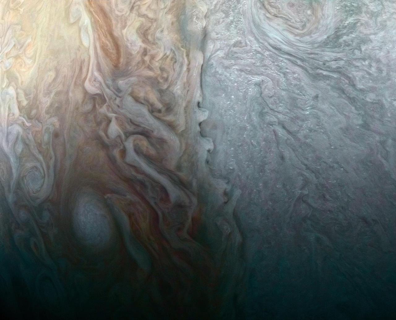 This image, taken by the JunoCam imager on NASA's Juno spacecraft, highlights a feature on Jupiter where multiple atmospheric conditions appear to collide. This publicly selected target is called "STB Spectre." The ghostly bluish streak across the right half of the image is a long-lived storm, one of the few structures perceptible in these whitened latitudes where the south temperate belt of Jupiter would normally be. The egg-shaped spot on the lower left is where incoming small dark spots make a hairpin turn. The image was taken on March 27, 2017, at 2:06 a.m. PDT (5:06 a.m. EDT), as the Juno spacecraft performed a close flyby of Jupiter. When the image was taken, the spacecraft was 7,900 miles (12,700 kilometers) from the planet. The image was processed by Roman Tkachenko, and the description is from John Rogers, the citizen scientist who identified the point of interest. https://photojournal.jpl.nasa.gov/catalog/PIA21388 . - Enhanced image by Roman Tkachenko (CC-BY) based on images provided courtesy of NASA/JPL-Caltech/SwRI/MSSS
