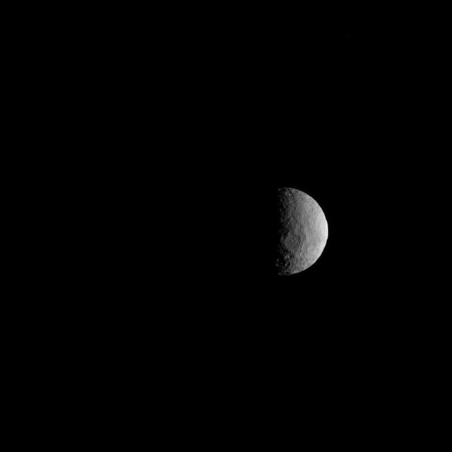 NASA's Dawn spacecraft took this picture on its way to a new orbit, at an altitude of about 30,000 miles (48,300 kilometers), as part of a series of images intended to help the navigation of the spacecraft relative to Ceres. The image was taken on March 28, 2017. Several familiar features can be identified: At the top, we see Occator Crater and its faculae (bright deposits identified as a mixture of sodium carbonate and other salts). Below center is the crater Urvara, and to the right of it, the larger crater Yalode (the third and second largest craters on Ceres, respectively). Large-scale faults called Samhain Catenae stretch from the Occator region toward the Yalode-Urvara region. The spacecraft will settle into a new orbit that will allow it to observe Ceres in opposition at the end of April 2017, when Dawn is directly between the sun and the Occator bright spots, at an altitude of about 12,400 miles (20,000 kilometers). The Dawn Journal has more details about the science expected from these observations. https://photojournal.jpl.nasa.gov/catalog/PIA21401