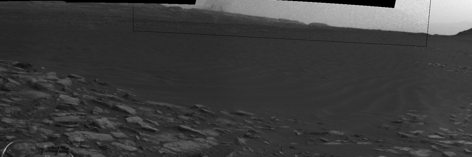 This image from an animation shows effects of one Martian day of wind blowing sand underneath NASA's Curiosity Mars rover on a non-driving day for the rover. Each image was taken just after sundown by the rover's downward-looking Mars Descent Imager (MARDI). The area of ground shown in the images spans about 3 feet (about 1 meter) left-to-right.  The first image was taken on Jan. 23, 2017, during the 1,587th Martian day, or sol, of Curiosity's work on Mars. Figure 1 above is the image with a scale bar in centimeters. The second was taken on Jan. 24, 2017 (Sol 1588). The day-apart images by MARDI were taken as a part of investigation of wind's effects during Martian summer, the windiest time of year in Gale Crater.   An animation is available at http://photojournal.jpl.nasa.gov/catalog/PIA21143