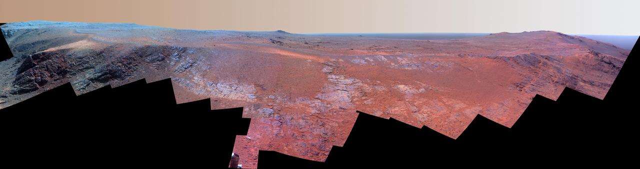 A ridge called "Rocheport" on the western rim of Mars' Endeavour Crater spans this mosaic of images from the panoramic camera (Pancam) on NASA's Mars Exploration Rover Opportunity. In this version of the scene the landscape is presented in enhanced color to make differences in surface materials more easily visible.  The view extends from south-southeast on the left to north on the right. Rocheport is near the southern end of an Endeavour rim segment called "Cape Tribulation." The Pancam took the component images for this panorama on Feb. 25, 2017, during the 4,654th Martian day, or sol, of Opportunity's work on Mars. Opportunity began exploring the western rim of Endeavour Crater in 2011 and reached the north end of Cape Tribulation in 2014.  This ridge bears some grooves on its side, such as between the two dark shoulders angling down near the left edge of the scene. For scale, those shoulders are about 10 to 16 feet (3 to 5 meters) long. The grooves might have been carved long ago by water or ice or wind.  The Rocheport name comes from a riverbank town in Missouri along the route of Lewis and Clark's "Corps of Discovery" Expedition.  The view merges exposures taken through three of the Pancam's color filters, centered on wavelengths of 753 nanometers (near-infrared), 535 nanometers (green) and 432 nanometers (violet).  https://photojournal.jpl.nasa.gov/catalog/PIA21492
