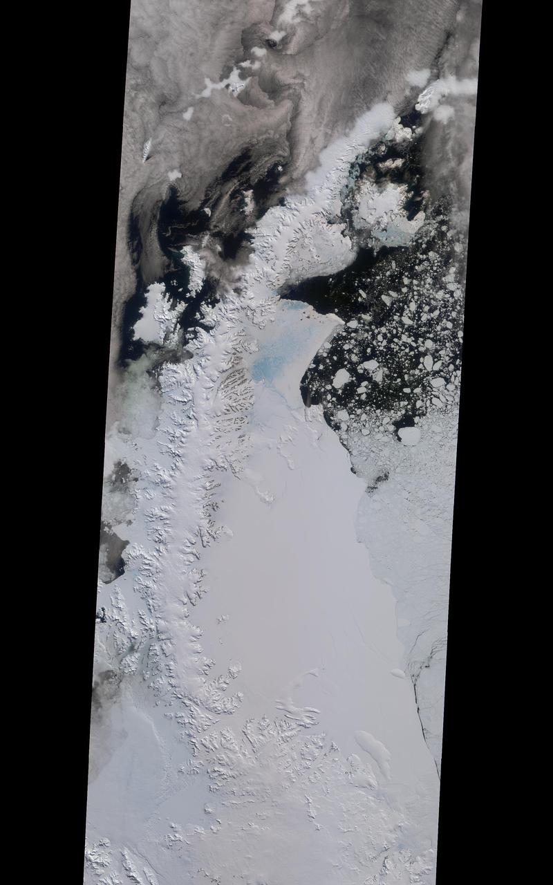 A rift in Antarctica's Larsen C ice shelf has grown to 110 miles (175 km) long, making it inevitable that an iceberg larger than Rhode Island will soon calve from the ice shelf. Larsen C is the fourth largest ice shelf in Antarctica, with an area of almost 20,000 square miles (50,000 square kilometers). The calving event will remove approximately 10 percent of the ice shelf's mass, according to the Project for Impact of Melt on Ice Shelf Dynamics and Stability (MIDAS), a UK-based team studying the ice shelf. Only 12 miles (20 km) of ice now separates the end of the rift from the ocean. The rift has grown at least 30 miles (50 km) in length since August, but appears to be slowing recently as Antarctica returns to polar winter. Project MIDAS reports that the calving event might destabilize the ice shelf, which could result in a collapse similar to what occurred to the Larsen B ice shelf in 2002.  The Multi-angle Imaging SpectroRadiometer (MISR) instrument aboard NASA's Terra satellite captured views of Larsen C on August 22, 2016, when the rift was 80 miles (130 km) in length; December 8, 2016, when the rift was approximately 90 miles (145 km) long; and April 6, 2017. The MISR instrument has nine cameras, which view the Earth at different angles. The overview image, from December 8, shows the entire Antarctic Peninsula -- home to Larsen A, B, and C ice shelves -- in natural color (similar to how it would appear to the human eye) from MISR's vertical-viewing camera.  Combining information from several MISR cameras pointed at different angles gives information about the texture of the ice. The accompanying GIF depicts the inset area shown on the larger image and displays data from all three dates in false color. These multiangular views -- composited from MISR's 46-degree backward-pointing camera, the nadir (vertical-viewing) camera, and the 46-degree forward-pointing camera -- represent variations in ice texture as changes in color, such that areas of rough ice appear orange and smooth ice appears blue. The Larsen C shelf is on the left in the GIF, bordered by the Weddell Sea on the upper right. The ice within the rift is orange, indicating movement, and the end of the rift can be tracked across the shelf between images. In addition, between December and April, the rift widened, pushing the future iceberg away from the shelf at its southern end.  These data were acquired during Terra orbits 88717, 90290 and 92023.  https://photojournal.jpl.nasa.gov/catalog/PIA21581