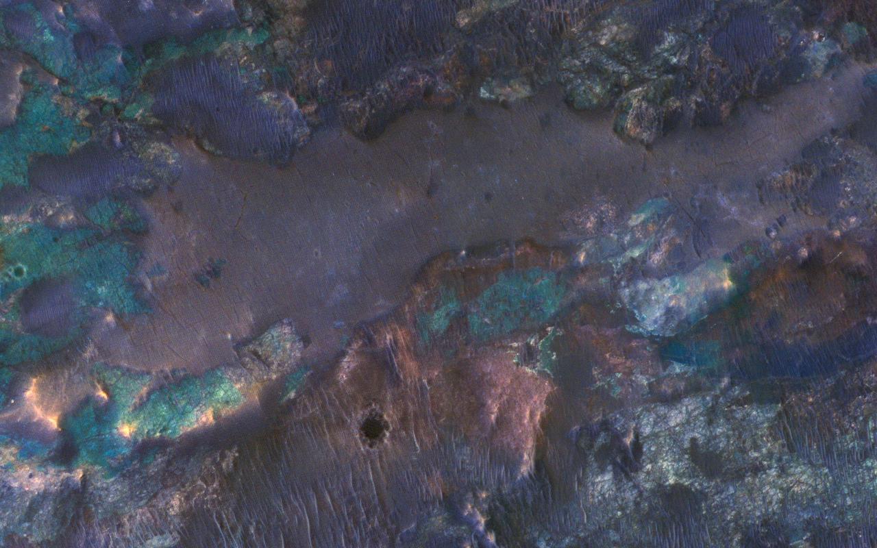 The collision that created Hargraves Crater impacted into diverse bedrock lithologies of ancient Mars; the impact ejecta is a rich mix of rock types with different colors and textures, as seen by NASA Mars Reconnaissance Orbiter.  The crater is named after Robert Hargraves who discovered and studied meteorite impacts on the Earth.  https://photojournal.jpl.nasa.gov/catalog/PIA21609