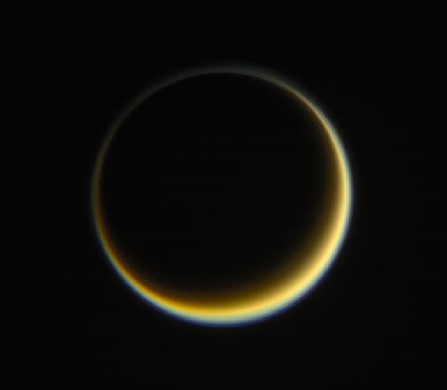NASA's Cassini spacecraft looks toward the night side of Saturn's moon Titan in a view that highlights the extended, hazy nature of the moon's atmosphere. During its long mission at Saturn, Cassini has frequently observed Titan at viewing angles like this, where the atmosphere is backlit by the Sun, in order to make visible the structure of the hazes. Titan's high-altitude haze layer appears blue here, whereas the main atmospheric haze is orange. The difference in color could be due to particle sizes in the haze. The blue haze likely consists of smaller particles than the orange haze. Images taken using red, green and blue spectral filters were combined to create this natural-color view. The image was taken with the Cassini spacecraft narrow-angle camera on May 29, 2017. The view was acquired at a distance of approximately 1.2 million miles (2 million kilometers) from Titan. Image scale is 5 miles (9 kilometers) per pixel. https://photojournal.jpl.nasa.gov/catalog/PIA21625