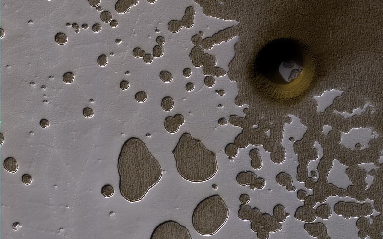 A South Polar Pit or an Impact Crater?