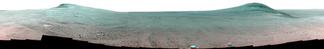 This June 2017 stereo scene from NASA's Mars Exploration Rover Opportunity rover shows the area just above "Perseverance Valley" on the rim of Endeavour Crater. The view combines images from the left eye and right eye of the rover's panoramic camera (Pancam) to appear three-dimensional when seen through blue-red glasses with the red lens on the left.  Toward the right side of the scene is a broad notch in the crest of the crater's rim. Opportunity left wheel tracks in that area as it observed Perseverance Valley from above in the spring of 2017. The valley is a major destination for the rover's extended mission. It descends out of sight on the inner slope of the rim, extending down and eastward from that notch.  Opportunity's Pancam took the component images for this view from a position outside the crater during the span of June 7 to June 19, 2017, sols 4753 to 4765 of the rover's work on Mars.  This scene includes features that might have been ancient channels from water, ice or wind moving toward the notch in the rim, which might have been a spillway. Perseverance Valley, just on the other side, was likely carved by action of some fluid, such as water, water-lubricated debris, or wind. The mission is investigating to learn more about that process from evidence in place.  The panorama spans about three-fourths of a full-circle view, from southeastward on the left, through westward in the middle, to northeastward on the right. High points visible on the rim of Endeavour Crater include "Winnemucca" on the left and "Cape Tribulation" on the right. Winnemucca is part of the "Cape Byron" portion of the crater rim. The horizon at far right extends across the floor of Endeavour Crater, which is about 14 miles (22 kilometers) in diameter. Opportunity has been investigating sites on and near the western rim of Endeavour since 2011, following seven years of exploring smaller craters after its 2004 landing  The rover team calls this the "Sprained Ankle" panorama because the images were collected during a driving moratorium while engineers diagnosed a temporary steering stall with one front wheel pointed outward more than 30 degrees. The team was able to straighten the wheel to point straight ahead, and then resumed driving.  The location from which this scene was recorded is labeled as "Sol 4752" on a later traverse map. Opportunity subsequently entered the upper end of Perseverance Valley and returned views looking down the valley and back up toward the rim crest from the location it reached on July 7 (Sol 4782).  You need 3D glasses to view this image.  https://photojournal.jpl.nasa.gov/catalog/PIA21721