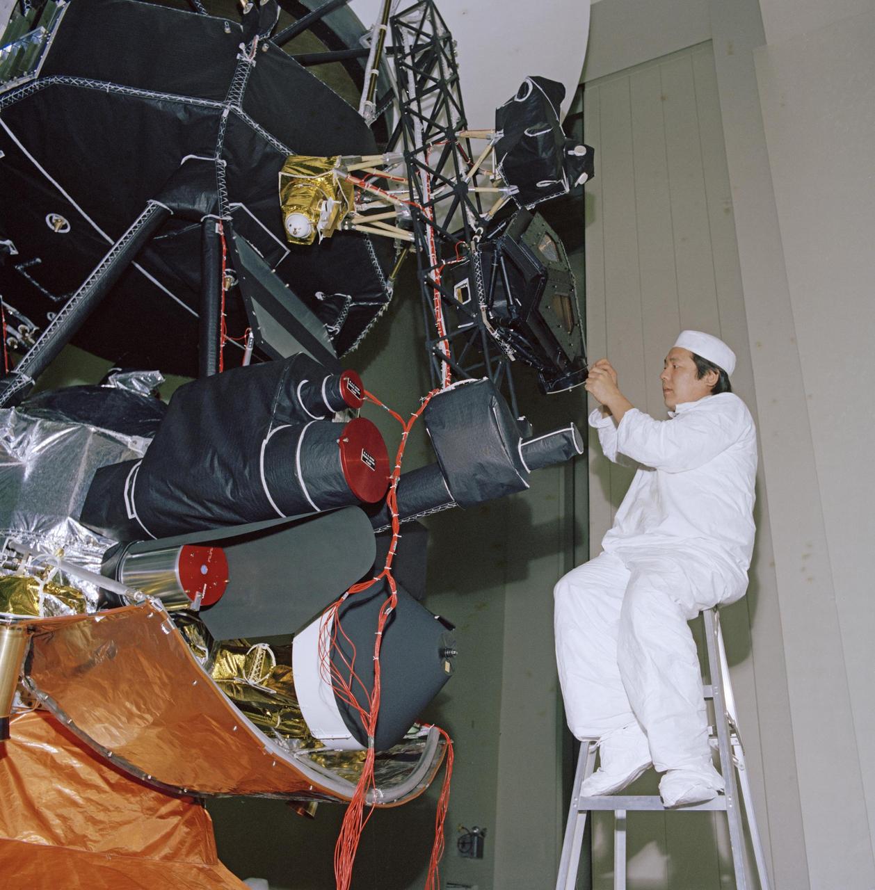 An engineer works on vibration acoustics and pyro shock testing for one of NASA's Voyager spacecraft on November 18, 1976. Several of the spacecraft's science instruments are visible at left.  https://photojournal.jpl.nasa.gov/catalog/PIA21733