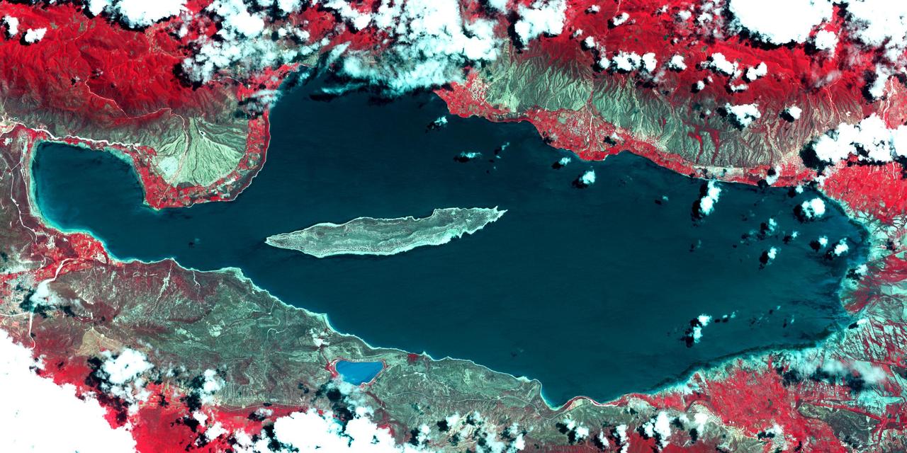 Lake Enriquillo is a hypersaline lake in the Dominican Republic. In 2004, the lake covered an area of 164 square kilometers; by 2011, it had doubled in size and grown to 350 km2, inundating farmland and homes. Various reasons for the flooding include increases in rainfall; increase of sediments going into the lake, raising the lakebed; and milder temperatures, reducing surface evaporation. The lake is home to the largest population of American crocodiles in the Caribbean. The images were acquired October 26, 2003 and June 10, 2017, cover an area of 22.7 by 45.4 km, and are located at 18.5 degrees north, 71.6 degrees west. An image of Lake Enriquillo taken in 2003 is available at https://photojournal.jpl.nasa.gov/catalog/PIA21815