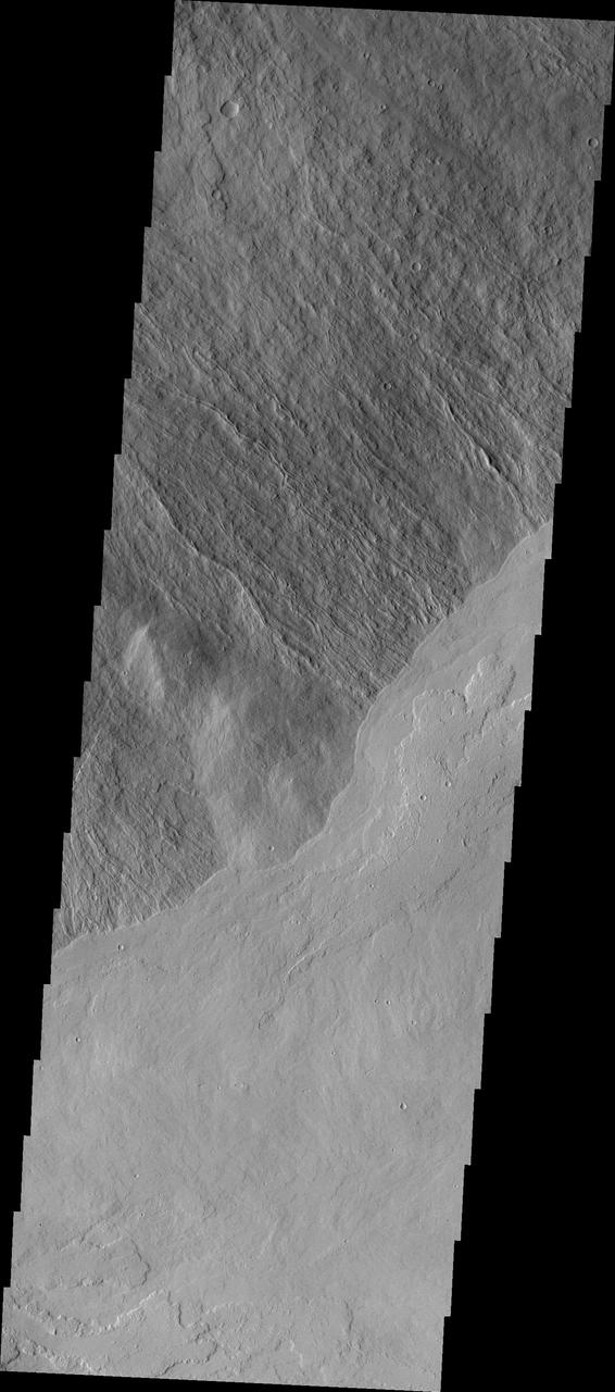 This image shows part of the southeastern flank of Ascraeus Mons. The narrow flows of the volcano dominate the top of the image, while younger volcanic plains cover the bottom of the image. The relative age designation is based on the fact that the brighter plains flows lap up against and cover the flank flows of Ascraeus Mons.  The Odyssey spacecraft has spent over 15 years in orbit around Mars, circling the planet more than 69000 times. It holds the record for longest working spacecraft at Mars. THEMIS, the IR/VIS camera system, has collected data for the entire mission and provides images covering all seasons and lighting conditions. Over the years many features of interest have received repeated imaging, building up a suite of images covering the entire feature. From the deepest chasma to the tallest volcano, individual dunes inside craters and dune fields that encircle the north pole, channels carved by water and lava, and a variety of other feature, THEMIS has imaged them all. For the next several months the image of the day will focus on the Tharsis volcanoes, the various chasmata of Valles Marineris, and the major dunes fields. We hope you enjoy these images!  Orbit Number: 10339 Latitude: 9.01699 Longitude: 257.294 Instrument: VIS Captured: 2004-04-13 17:23  https://photojournal.jpl.nasa.gov/catalog/PIA21820