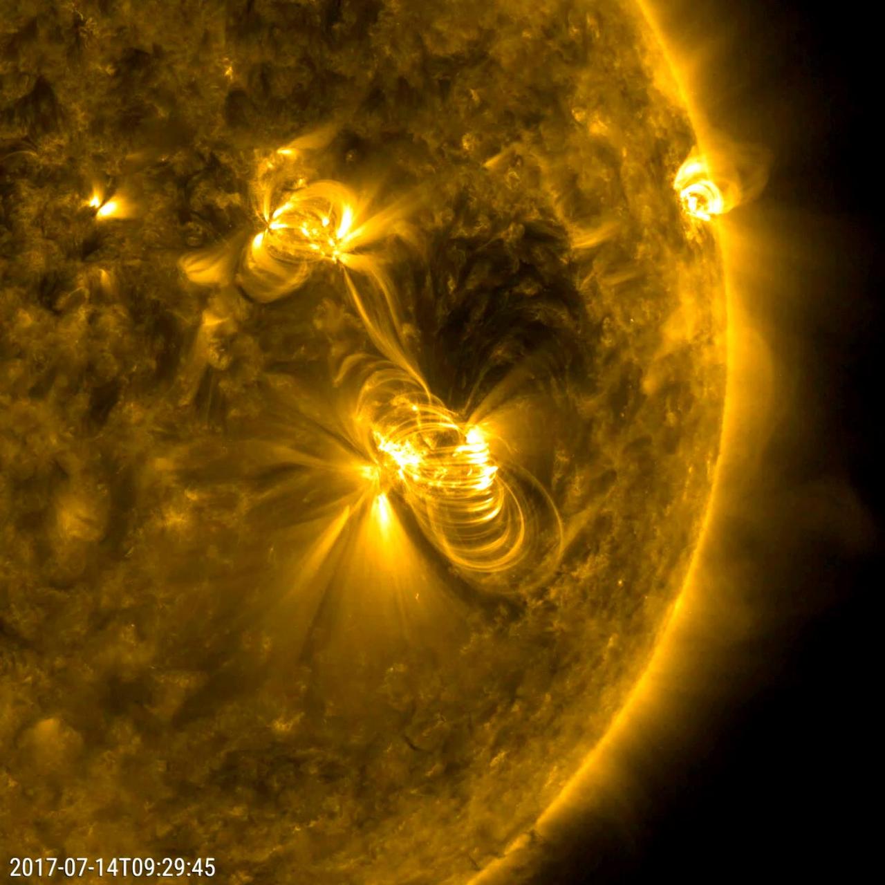 A flare medium-sized (M2) flare and a coronal mass ejection erupted from the same, large active region (July 14, 2017). The flare lasted almost two hours, quite a long duration. Coronagraphs on the SOHO spacecraft show a substantial cloud of charged particles blasting into space just after the blast. The coils arcing over this active region are particles spiraling along magnetic field lines, which were reorganizing themselves after the magnetic field was disrupted by the blast. Images were taken in a wavelength of extreme ultraviolet light. Movies are available at https://photojournal.jpl.nasa.gov/catalog/PIA21836