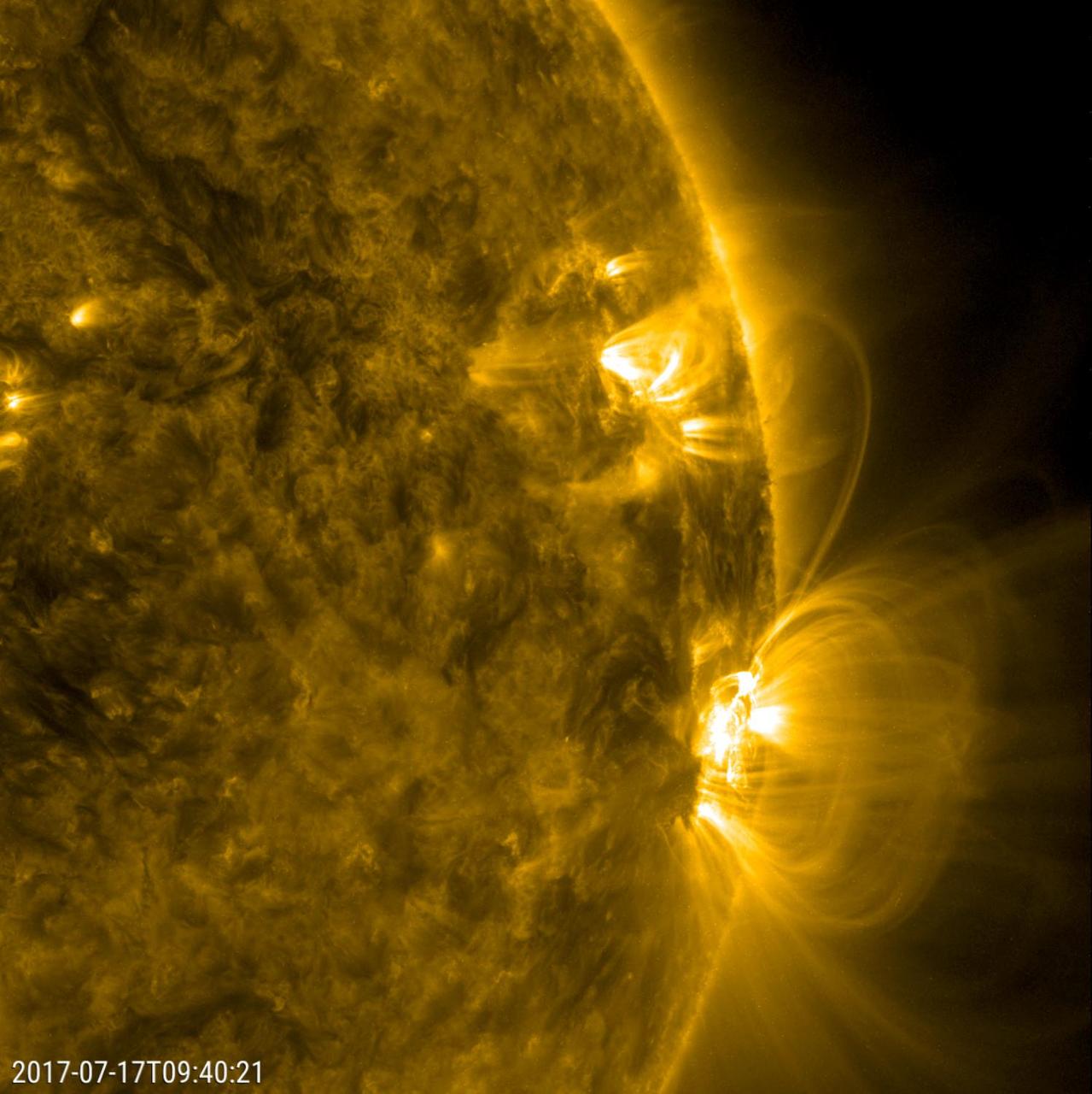Numerous arches of magnetic field lines danced and swayed above a large active region over about a 30-hour period (July 17-18, 2017). We can also see the magnetic field lines from the large active region reached out and connected with a smaller active region. Those linked lines then strengthened (become brighter), but soon began to develop a kink in them and rather swiftly faded from view. All of this activity is driven by strong magnetic forces associated with the active regions. The images were taken in a wavelength of extreme ultraviolet light.  https://photojournal.jpl.nasa.gov/catalog/PIA21838
