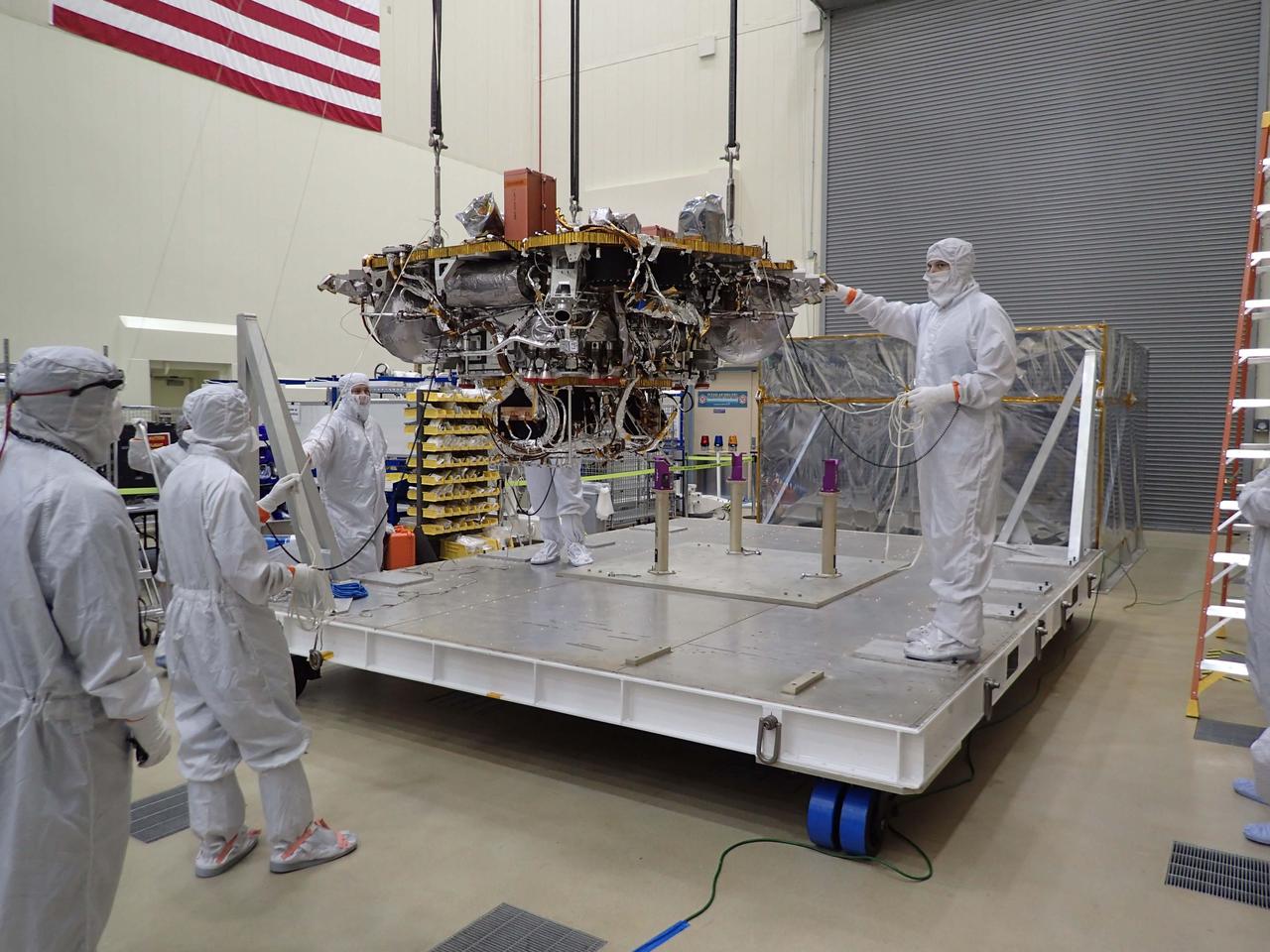 The Mars lander portion of NASA's InSight spacecraft is lifted from the base of a storage container in preparation for testing, in this photo taken June 20, 2017, in a Lockheed Martin clean room facility in Littleton, Colorado. The InSight mission (for Interior Exploration using Seismic Investigations, Geodesy and Heat Transport) is scheduled to launch in May 2018 and land on Mars Nov. 26, 2018. It will investigate processes that formed and shaped Mars and will help scientists better understand the evolution of our inner solar system's rocky planets, including Earth. https://photojournal.jpl.nasa.gov/catalog/PIA21844