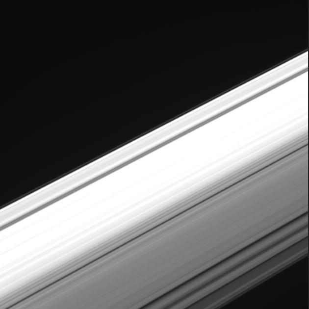 This image from NASA's Cassini spacecraft offers a unique perspective on Saturn's ring system. Cassini captured  images from within the gap between the planet and its rings, looking outward as the spacecraft made one of its final dives through the gap as part of the mission's Grand Finale.  Using its wide-angle camera, Cassini took the 21 images in the sequence over a span of about four minutes during its dive through the gap on Aug. 20, 2017. The images have an original size of 512 x 512 pixels; the smaller image size allowed for more images to be taken over the short span of time.  The entirety of the main rings can be seen here, but due to the low viewing angle, the rings appear extremely foreshortened. The perspective shifts from the sunlit side of the rings to the unlit side, where sunlight filters through. On the sunlit side, the grayish C ring looks larger in the foreground because it is closer; beyond it is the bright B ring and slightly less-bright A ring, with the Cassini Division between them. The F ring is also fairly easy to make out.  A movie is available at https://photojournal.jpl.nasa.gov/catalog/PIA21886