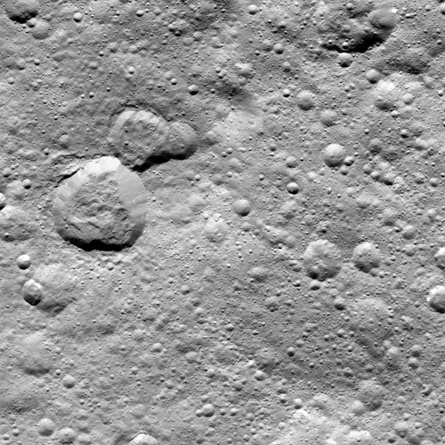 This image from NASA's Dawn spacecraft shows a group of craters, left of center, that resembles a rubber duck. Halki Crater, the "head," is 12 miles (20 kilometers) in diameter, while Telepinu Crater, the "body," is 19 miles (31 kilometers) across. They can be found in the global map of Ceres' names. The "beak" crater is unnamed. Halki and Telepinu have both been recently added to the list of official names for Ceres' geological features. They are both named after Hittite (Asia Minor) deities: the goddess of grain and the god of fertility and vegetation, respectively. Dawn acquired this picture on August 20, 2015, from its high-altitude mapping orbit at about 915 miles (1,470 kilometers) above the surface. The center coordinates of this image are 26 degrees north latitude, 339 degrees east longitude. https://photojournal.jpl.nasa.gov/catalog/PIA21909