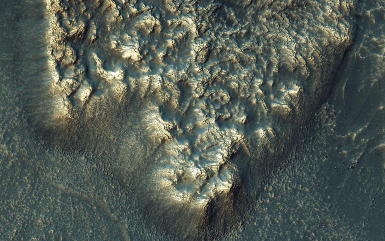 NASA's Mars Reconnaissance Orbiter observes many slopes in the middle latitudes of Mars showing icy flows or glaciers. The region shown here, in the south-facing slope of a crater, is unusual because the flows have bright highlights. The color and brightness variations are likely due to surface coatings of bright dust and dark sand. There is no evidence that these flows are currently active, but they may have been active only millions of years ago. These flows may well contain ice today in their interiors, as confirmed in places by the subsurface radar experiment on MRO. https://photojournal.jpl.nasa.gov/catalog/PIA21953