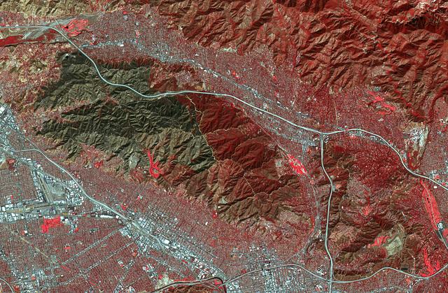 On Sept. 1, 2017, the La Tuna Canyon fire began in the foothills north of Los Angeles. By the time it was contained, it became one of the biggest wildfires in the history of the city in terms of sheer acreage. The fire burned several structures and resulted in a large number of evacuations. The fire could be seen over a large area, from the Hollywood Burbank airport (left side of image), to NASA's Jet Propulsion Laboratory and the Rose Bowl (right side of image). In this image from the Advanced Spaceborne Thermal Emission and Reflection Radiometer (ASTER) instrument on NASA's Terra satellite, vegetation is depicted in red (golf courses are particularly prominent), and the burned area is in dark gray. The image was acquired Oct. 7, 2017, covers an area of approximately 8 by 13 miles (13.5 by 20.5 kilometers), and is located at 34.2 degrees north, 118.2 degrees west.  https://photojournal.jpl.nasa.gov/catalog/PIA22044