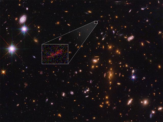 This Hubble Space Telescope image shows the farthest galaxy yet seen in an image that has been stretched and amplified by a phenomenon called gravitational lensing. The embryonic galaxy, named SPT0615-JD, existed when the universe was just 500 million years old. Though a few other primitive galaxies have been seen at this early epoch, they have essentially all looked like red dots, given their small size and tremendous distances. However, in this case, the gravitational field of a massive foreground galaxy cluster, called SPT-CL J0615-5746, not only amplified the light from the background galaxy but also smeared the image of it into an arc (about 2 arcseconds long). Image analysis shows that the galaxy weighs in at no more than 3 billion solar masses (roughly 1/100th the mass of our fully grown Milky Way galaxy). It is less than 2,500 light-years across, half the size of the Small Magellanic Cloud, a satellite galaxy of our Milky Way. The object is considered prototypical of young galaxies that emerged during the epoch shortly after the big bang.   https://photojournal.jpl.nasa.gov/catalog/PIA22079