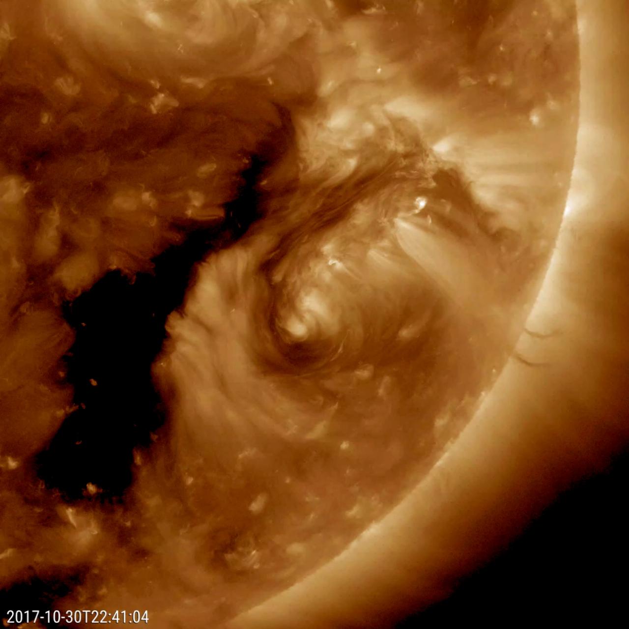 NASA's Solar Dynamics Observatory came across an oddity this week that the spacecraft has rarely observed before: a dark filament encircling an active region (Oct. 29-31, 2017). Solar filaments are clouds of charged particles that float above the sun, tethered to it by magnetic forces. They are usually elongated and uneven strands. Only a handful of times before have we seen one shaped like a circle. (The black area to the left of the brighter active region is a coronal hole, a magnetically open region of the sun). While it may no major scientific value, it is noteworthy because of its rarity. The still and video clip were taken in a wavelength of extreme ultraviolet light.  Movies are available at https://photojournal.jpl.nasa.gov/catalog/PIA22104