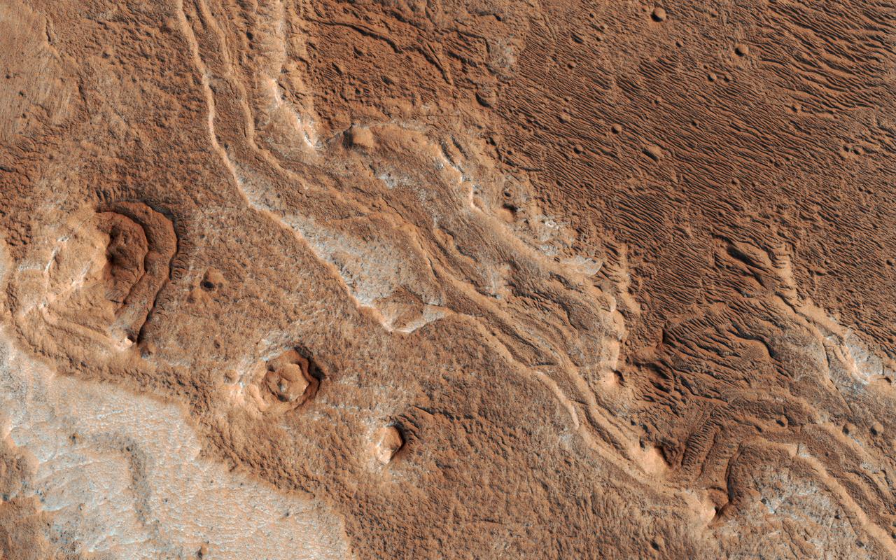 Layers, probably sedimentary in origin, have undergone extensive erosion in this image from NASA's Mars Reconnaissance Orbiter (MRO) of Shalbatana Valles, a prominent channel that cuts through Xanthe Terra.  This erosion has produced several small mesas and exposed light-toned material that may differ in composition from the surrounding material.  The map is projected here at a scale of 25 centimeters (9.8 inches) per pixel. [The original image scale is 27.5 centimeters (10.8 inches) per pixel (with 1 x 1 binning); objects on the order of 82 centimeters (32.3 inches) across are resolved.] North is up.  https://photojournal.jpl.nasa.gov/catalog/PIA22182