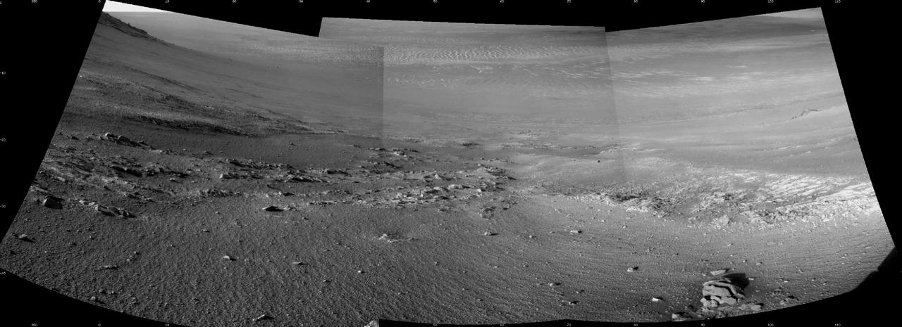 Textured rows on the ground in this portion of "Perseverance Valley" are under investigation by NASA's Mars Exploration Rover Opportunity, which used its Navigation Camera (Navcam) to take the component images of this downhill-looking scene.  The rover took this image on Jan. 4, 2018, during the 4,958th Martian day, or sol, of its work on Mars, looking downhill from a position about one-third of the way down the valley. Perseverance Valley descends the inboard slope of the western rim of Endeavour Crater. A view on the same sol with the rover's front Hazard Avoidance Camera includes ground even closer to the rover at this site. Opportunity was still working close by as it reached the mission's Sol 5,000 (Feb. 16, 2018).  In the portion of the valley seen here, soil and gravel have been shaped into a striped pattern in the foreground and partially bury outcrops visible in the midfield. The long dimensions of the stripes are approximately aligned with the downhill direction. The striped pattern resembles a type of feature on Earth (such as on Hawaii's Mauna Kea) that is caused by repeated cycles of freezing and thawing, though other possible origins are also under consideration for the pattern in Perseverance Valley.  The view is spans from north on the left to east-southeast on the right. For scale, the foreground rock clump in the lower right is about 11 inches (28 centimeters) in width.   https://photojournal.jpl.nasa.gov/catalog/PIA22217