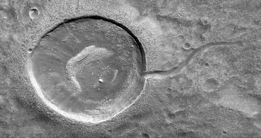 This image from NASA's Mars Reconnaissance Orbiter (MRO) shows an impact crater looking amusingly like a tadpole because of the valley that was carved by water that used to fill it.  It is often difficult to differentiate between inlet and outlet channels, but water always flows downhill. In this particular case, we can infer that water is flowing outward because we have the necessary terrain-height information.  When studying these images in detail, scientists can gain a better understanding of the strength of the flooding water that carved the channels, and better understand the history of water activity in this region of Mars.  https://photojournal.jpl.nasa.gov/catalog/PIA22241