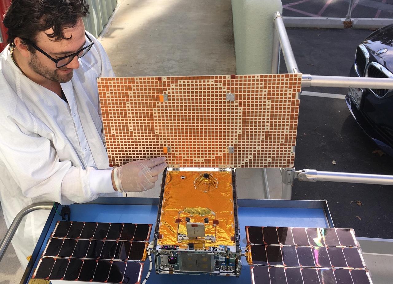Engineer Joel Steinkraus uses sunlight to test the solar arrays on one of the Mars Cube One (MarCO) spacecraft at NASA's Jet Propulsion Laboratory. The MarCOs will be the first CubeSats -- a kind of modular, mini-satellite -- flown into deep space. They're designed to fly along behind NASA's InSight lander on its cruise to Mars. If they make the journey, they will test a relay of data about InSight's entry, descent and landing back to Earth. Though InSight's mission will not depend on the success of the MarCOs, they will be a test of how CubeSats can be used in deep space.  https://photojournal.jpl.nasa.gov/catalog/PIA22318