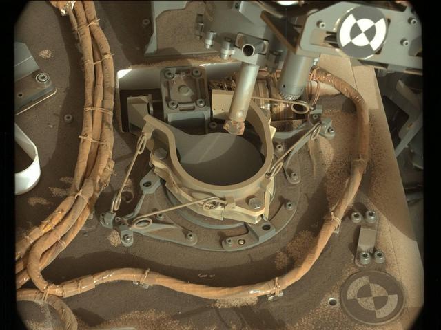 The drill bit of NASA's Curiosity Mars rover over one of the sample inlets on the rover's deck. The inlets lead to Curiosity's onboard laboratories. This image was taken on Sol 2068 by the rover's Mast Camera (Mastcam).  https://photojournal.jpl.nasa.gov/catalog/PIA22327