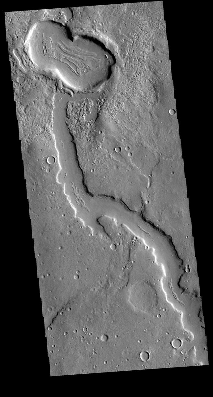 The northern margins of Arabia Terra and Terra Sabaea contain many unnamed channels. This channel is located in Terra Sabaea. The channel flow is toward the top of the image. This channel has been covered by craters at the top of the image, showing that the channel flow occurred prior to the impacts that created the craters. Orbit Number: 71240 Latitude: 37.1087 Longitude: 40.9077 Instrument: VIS Captured: 2018-01-05 01:18 https://photojournal.jpl.nasa.gov/catalog/PIA22376