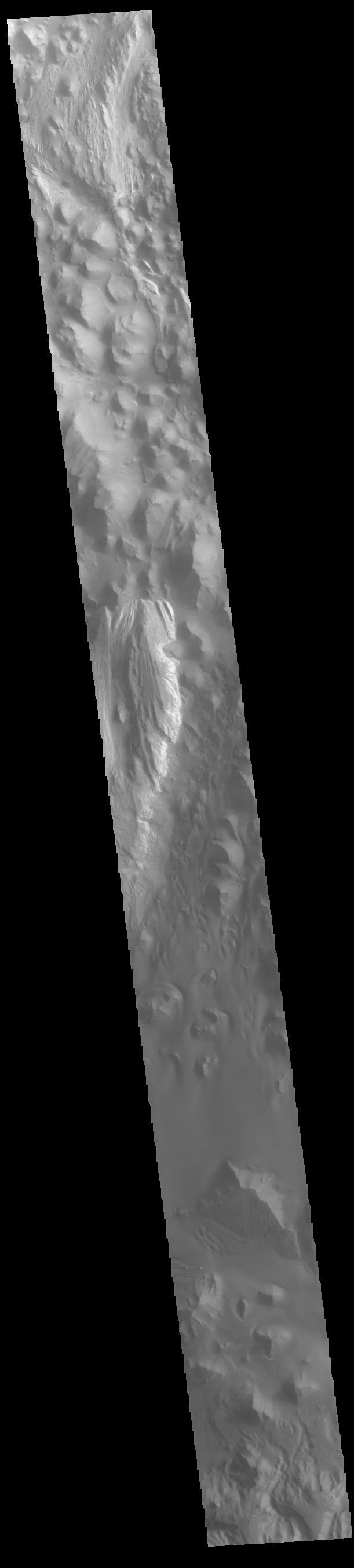 This VIS image runs from northern Juventae Chasma to just short of the southern canyon wall. Illustrating the variety of landforms within the chasma, this image contains the rough canyon floor at the northern extent of the chasma, layered materials in the center of the image and dunes located in the southern, deepest section of the chasma.  Orbit Number: 71356 Latitude: -3.55335 Longitude: 298.389 Instrument: VIS Captured: 2018-01-14 14:25  https://photojournal.jpl.nasa.gov/catalog/PIA22381