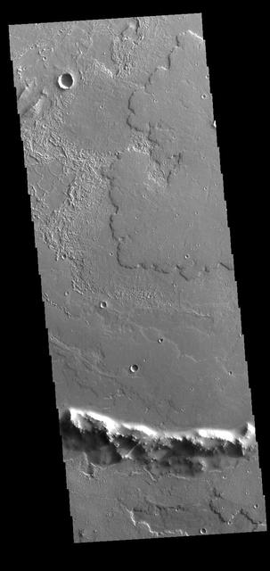 At the bottom of this VIS image of Daedalia Planum is the uppermost rim of an impact crater. The unnamed crater has been almost completely filled by lava flows originating from Arsia Mons. Orbit Number: 71346 Latitude: -21.6885 Longitude: 229.536 Instrument: VIS Captured: 2018-01-13 18:33 https://photojournal.jpl.nasa.gov/catalog/PIA22382