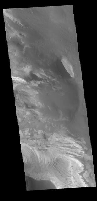 Today's VIS image shows part of the interior of Candor Chasma. At the bottom of the frame is a bright feature formed by layers of material deposited in the canyon after it formed. Additional darker material is likely sand blown into the canyon and eroded from rocks within the chasma. Candor Chasma is just one of the canyons that make up Valles Marineris.  Orbit Number: 71344 Latitude: -6.20728 Longitude: 285.115 Instrument: VIS Captured: 2018-01-13 14:41  https://photojournal.jpl.nasa.gov/catalog/PIA22388
