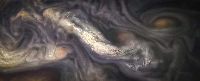 This image captures a high-altitude cloud formation surrounded by swirling patterns in the atmosphere of Jupiter's North North Temperate Belt region.  The North North Temperate Belt is one of Jupiter's many colorful, swirling cloud bands. Scientists have wondered for decades how deep these bands extend. Gravity measurements collected by Juno during its close flybys of the planet have now provided an answer. Juno discovered that these bands of flowing atmosphere actually penetrate deep into the planet, to a depth of about 1,900 miles (3,000 kilometers).  NASA's Juno spacecraft took this color-enhanced image at 10:11 p.m. PDT on July 15, 2018 (1:11 a.m. EDT on July 16), as the spacecraft performed its 14th close flyby of Jupiter. At the time, Juno was about 3,900 miles (6,200 kilometers) from the planet's cloud tops, above a latitude of 36 degrees. Citizen scientist Jason Major created this image using data from the spacecraft's JunoCam imager. https://photojournal.jpl.nasa.gov/catalog/PIA22426 .  -   Enhanced image by Jason Major based on images provided courtesy of NASA/JPL-Caltech/SwRI/MSSS