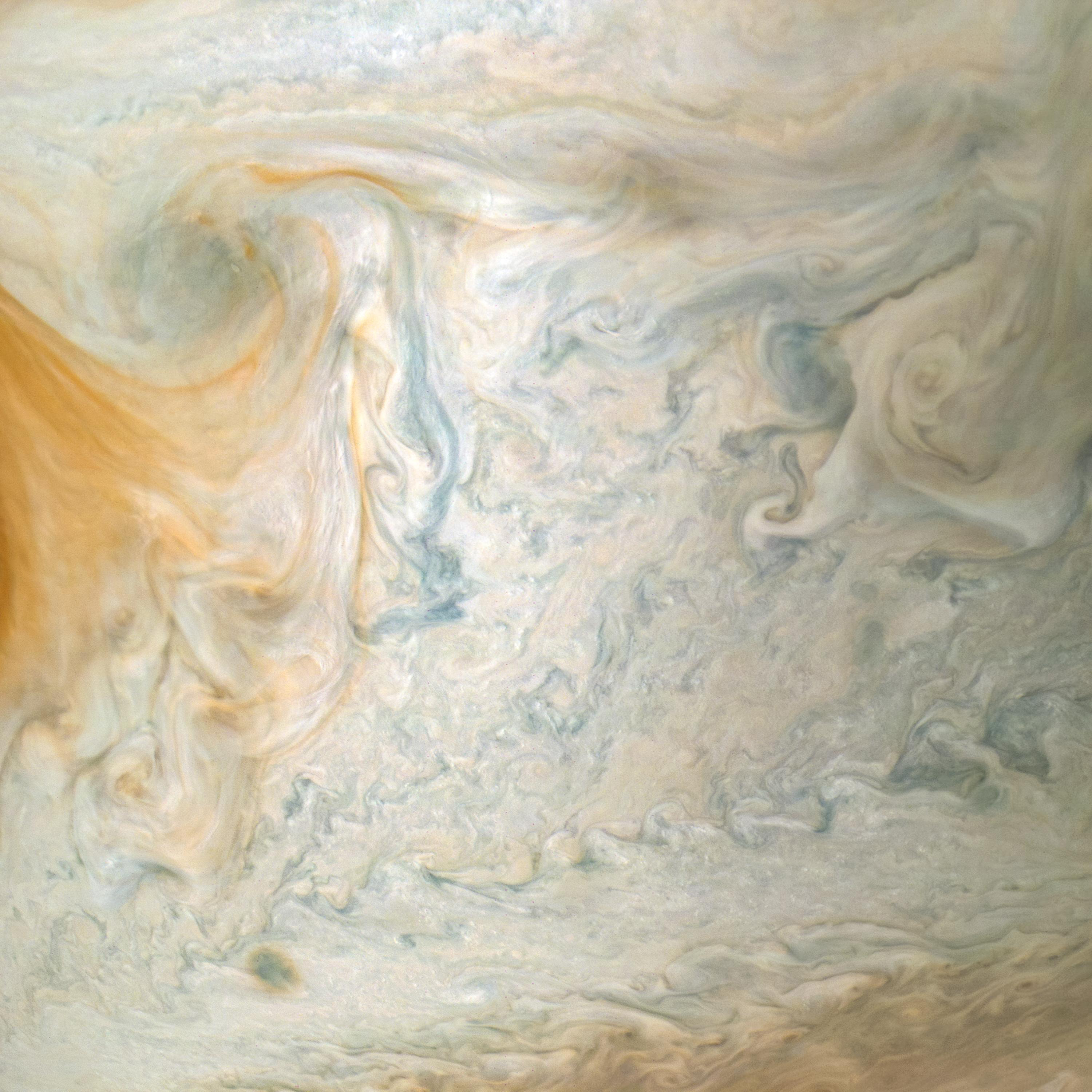 The easternmost edge of Jupiter's Great Red Spot and surrounding south tropical disturbance are captured in this image from NASA's Juno spacecraft. At left, wispy tendrils from the Red Spot give the atmosphere a layered appearance as they partially obscure cloud features below.  Jupiter's appearance is a tapestry of vivid colors and swirling atmospheric vortices. Many aspects of the planet's atmosphere are still a mystery. For example, the origin of individual storms or churning cloud features is unknown. By studying Jupiter's weather up close for the first time, Juno is helping researchers better understand how atmospheres work in general -- including our own. What we learn about Jupiter's atmosphere will also help scientists understand how gas-giant planets work in general, including those now being discovered beyond our solar system.  This color-enhanced image was taken at 3:01 a.m. PDT on April 1, 2018 (6:01 a.m. EDT), as the spacecraft performed its 12th close flyby of Jupiter. At the time, Juno was about 7,900 miles (12,750 kilometers) from the planet's cloud tops, above a southern latitude of approximately 26 degrees. Citizen scientist Kevin M. Gill created this image using data from the spacecraft's JunoCam imager. https://photojournal.jpl.nasa.gov/catalog/PIA22429 . -   Enhanced image by Kevin M. Gill (CC-BY) based on images provided courtesy of NASA/JPL-Caltech/SwRI/MSSS