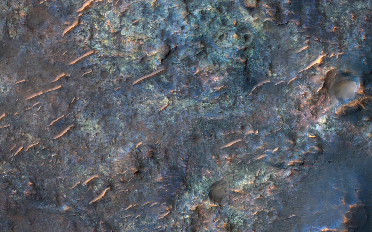 This image from NASA's Mars Reconnaissance Orbiter (MRO) shows bedrock units with diverse colors indicating different mineral concentrations. More information is available at https://photojournal.jpl.nasa.gov/catalog/PIA22434