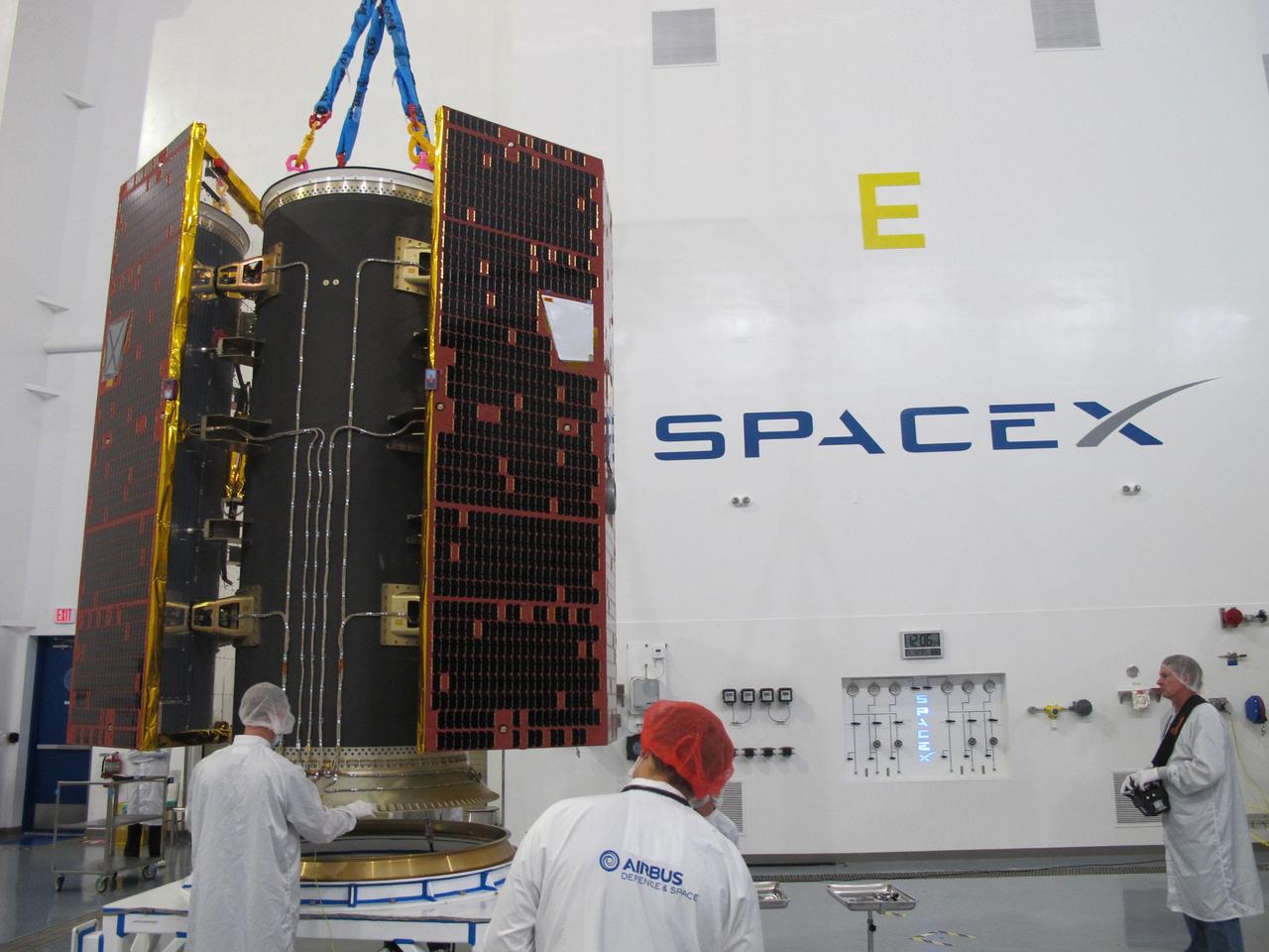 Technicians inspect the twin GRACE Follow-On satellites and their multi-satellite dispenser at the SpaceX facility at Vandenberg Air Force Base in California. The satellites were subsequently stacked atop another satellite dispenser containing the five Iridium NEXT communications satellites they will share a ride to orbit with.   https://photojournal.jpl.nasa.gov/catalog/PIA22452