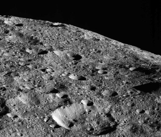 On the way to its lowest-ever and final orbit, NASA's Dawn spacecraft is observing Ceres and returning new compositional data (infrared spectra) and images of the dwarf planet's surface, such as this dramatic image of Ceres' limb. This picture is one of the first images returned by Dawn in more than a year. Dawn captured this view on May 16, 2018 from an altitude of about 270 miles (440 kilometers). The large crater near the horizon is about 22 miles (35 kilometers) in diameter. It is located at about 23 degrees north latitude, 350 degrees east longitude, not far from a series of tholi (small mountains) that include Kwanzaa Tholus. The midsize crater in the foreground is located about 75 miles (120 kilometers) from the large crater. This rough landscape suggests these features are on top of ancient terrains. The Dawn spacecraft has returned many limb images of Ceres in the course of its mission. These images offer complementary perspective to the images generally obtained by imaging the surface directly beneath the spacecraft. This example shows that Ceres' limb is relatively smooth despite the rough surface, because this large body is rounded by its own gravity. https://photojournal.jpl.nasa.gov/catalog/PIA22476