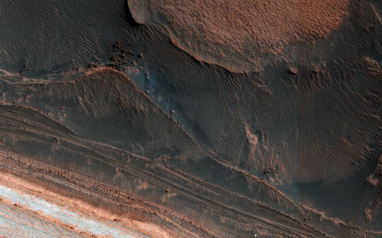 One of the most actively changing areas on Mars are the steep edges of the North Polar layered deposits. This image from NASA's Mars Reconnaissance Orbiter (MRO) shows many new ice blocks compared to an earlier image in December 2006. An animation shows one example, where a section of ice cliff collapsed. The older image (acquired in bin-2 mode) is not as sharp as the newer one. HiRISE has been re-imaging regions first photographed in 2006 through 2007, six Mars years ago. This long baseline allows us to see large, rare changes as well as many smaller changes. More information is available at https://photojournal.jpl.nasa.gov/catalog/PIA22535