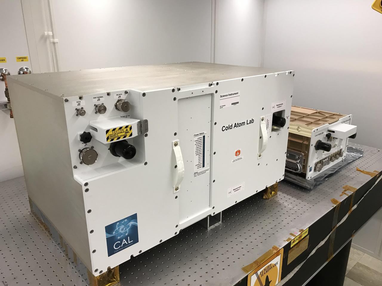 The Cold Atom Laboratory consists of two standardized containers that will be installed on the International Space Station. The larger container is called a "quad locker," and the smaller container is called a "single locker." The quad locker contains CAL's physics package, or the compartment where CAL will produce clouds of ultra-cold atoms.  https://photojournal.jpl.nasa.gov/catalog/PIA22562