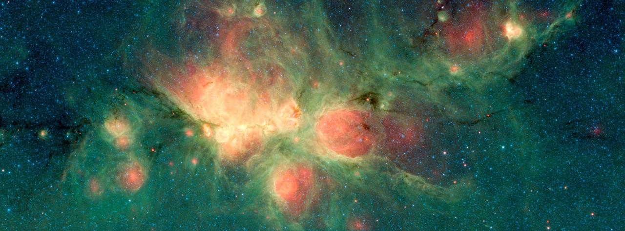 The Cat's Paw Nebula, imaged here by NASA's Spitzer Space Telescope, lies inside the Milky Way Galaxy and is located in the constellation Scorpius. Its distance from Earth is estimated to be between 1.3 kiloparsecs (about 4,200 light years) to 1.7 kiloparsecs (about 5,500 light years).  The bright, cloudlike band running left to right across the image shows the presence of gas and dust that can collapse to form new stars. The black filaments running through the nebula are particularly dense regions of gas and dust. The entire star-forming region is thought to be between 24 and 27 parsecs (80-90 light years) across. The stars that form inside the nebula heat up the pressurized gas surrounding them, such that the gas may expand and form "bubbles", which appear red in this image. Asymmetric bubbles may "burst," creating U-shaped features.  The green areas show regions where radiation from hot stars collided with large molecules and small dust grains called "polycyclic aromatic hydocarbons" (PAHs), causing them to fluoresce.  This image was compiled using data from two Spitzer instruments, the Infrared Array Camera (IRAC) and the Multiband Imaging Photometer (MIPS). The colors correspond with wavelengths of 3.6 microns (blue), 4.5 microns (cyan), 8 microns (green) and 24 microns (red).  https://photojournal.jpl.nasa.gov/catalog/PIA22568