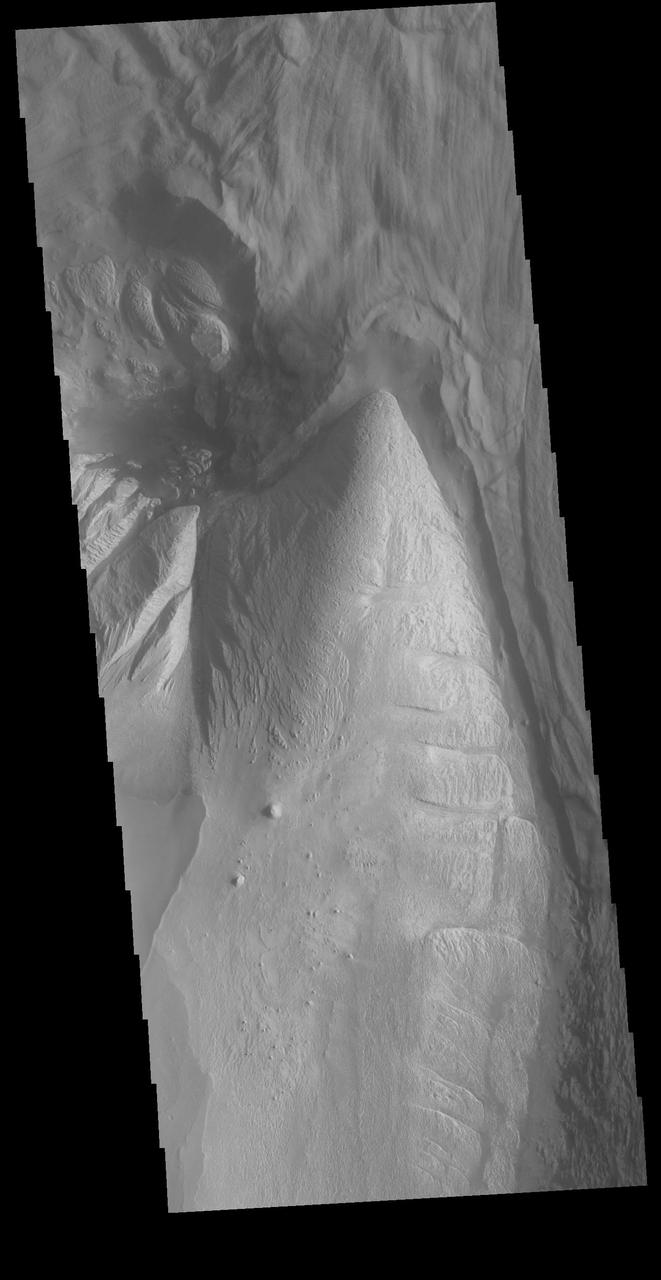Today's VIS image shows part of Ophir Chasma. Ophir Chasma is part of Valles Marineris, the largest canyon system on Mars. At the top of the image is a portion of a large landslide deposit which originate at the northern wall of the canyon. The bright toned part at the bottom of the image is the northern extent of Beatis Mensa, a large layered deposit within the canyon.  Orbit Number: 72429 Latitude: -3.9913 Longitude: 288.136 Instrument: VIS Captured: 2018-04-12 23:52  https://photojournal.jpl.nasa.gov/catalog/PIA22602