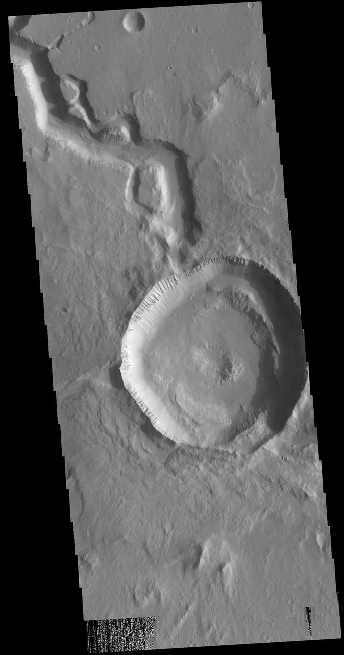 Today's VIS image shows a crater on Hephaestus Fossae. The crater is fairly young, as there is only minimal modification of the crater floor. While it appears that the crater sits of top of the channel, the creation of the crater may have also created the channel. The impact event would have caused subsurface heating, melting any subsurface ice in the region which would have created surface flow to form the channel. Orbit Number: 72447 Latitude: 17.8067 Longitude: 125.698 Instrument: VIS Captured: 2018-04-14 11:35 https://photojournal.jpl.nasa.gov/catalog/PIA22605
