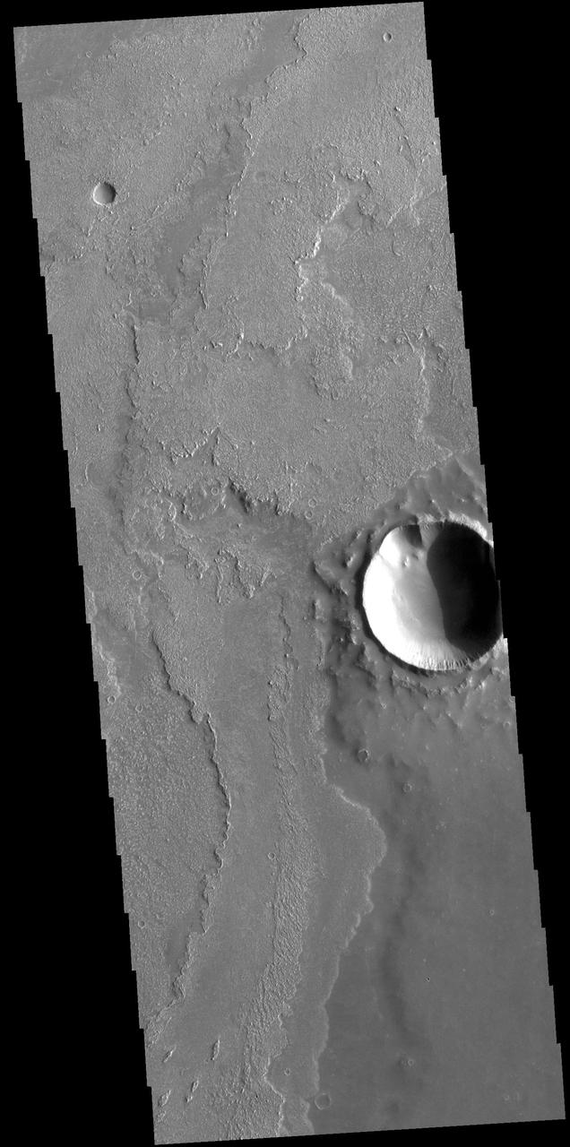 This VIS image shows a small portion of the vast lava flow field of Daedalia Planum. The flows originate at Arsia Mons, the youngest of the three Tharsis volcanoes. Orbit Number: 72493 Latitude: -20.9092 Longitude: 243.284 Instrument: VIS Captured: 2018-04-18 06:19 https://photojournal.jpl.nasa.gov/catalog/PIA22611