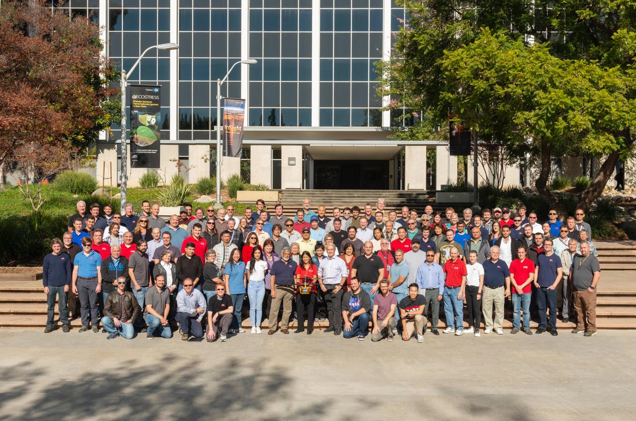 The Mars Helicopter team gathers for a group photo at NASA's Jet Propulsion Laboratory in Southern California on Dec. 3, 2018. Holding a full-size model of the helicopter, named Ingenuity, is MiMi Aung, the project manager at JPL.  https://photojournal.jpl.nasa.gov/catalog/PIA22649
