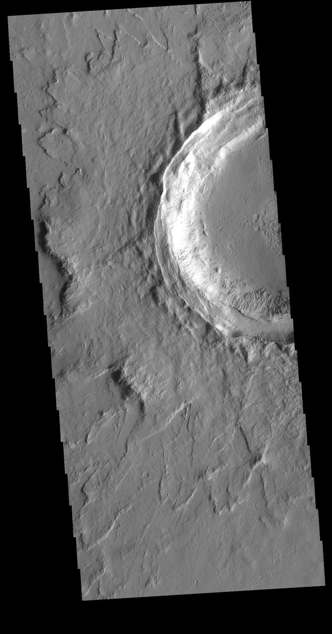 This VIS image shows an unnamed crater located northeast of Ascraeus Mons, on the volcanic plains of the Tharsis region. The rim has several concentric ridges. There are multiple layers of ejecta, with raised edges. The ejecta sits on top of the regional lava flows, indicating it formed after the lava flows covered the area. The lack of significant modification of both rim and ejecta show that this crater is relatively young. Orbit Number: 73066 Latitude: 19.1445 Longitude: 259.912 Instrument: VIS Captured: 2018-06-04 11:22 https://photojournal.jpl.nasa.gov/catalog/PIA22665