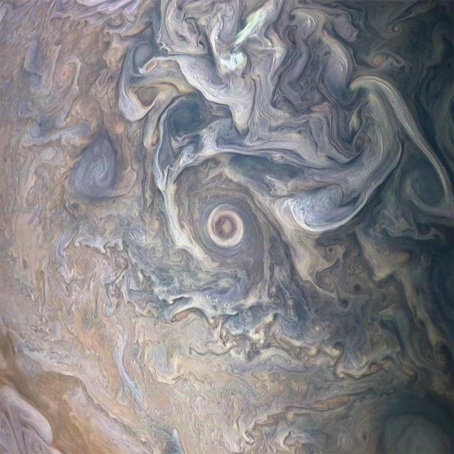Intricate swirls in Jupiter's volatile northern hemisphere are captured in this color-enhanced image from NASA's Juno spacecraft. Bursts of bright-white "pop-up" clouds appear scattered throughout the scene, with some visibly casting shadows on the neighboring cloud layers beneath them. Juno scientists are using shadows to determine the distances between cloud layers in Jupiter's atmosphere, which provide clues to their composition and origin. This image was taken at 10:27 p.m. PDT on May 23, 2018 (1:27 a.m. EDT on May 24) as the spacecraft performed its 13th close flyby of Jupiter. At the time, Juno was about 7,050 miles (11,350 kilometers) from the planet's cloud tops, above a northern latitude of approximately 49 degrees. Citizen scientists Gerald Eichstädt and Seán Doran created this image using data from the spacecraft's JunoCam imager. https://photojournal.jpl.nasa.gov/catalog/PIA22687