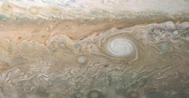 A swirling, oval white cloud in Jupiter's South South Temperate Belt is captured in this image from NASA's Juno spacecraft. Known as White Oval A5, the feature is an anticyclonic storm. An anticyclone is a weather phenomenon where winds around the storm flow in the direction opposite to those of the flow around a region of low pressure. Juno took the two images used to produce this color-enhanced view on Sept. 6, 2018, at 6:45 p.m. PDT (9:45 p.m. EDT) and 6:58 p.m. PDT (9:58 p.m. EDT) as the Juno spacecraft performed its 15th close flyby of Jupiter. At the time the images were taken, the spacecraft was about 25,000 miles (40,500 kilometers) to 39,000 miles (63,000 kilometers) from Jupiter's cloud tops, above a southern latitude spanning from about 54 to 66 degrees. https://photojournal.jpl.nasa.gov/catalog/PIA22691 . - Enhanced image by Kevin M. Gill (CC-BY) based on images provided courtesy of NASA/JPL-Caltech/SwRI/MSSS