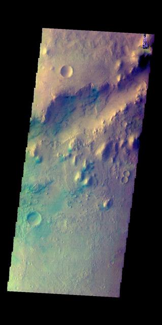 This image shows a small section of Nili Fossae. The darker blue tones are usually indications of basaltic sands. The THEMIS VIS camera contains 5 filters. The data from different filters can be combined in multiple ways to create a false color image. These false color images may reveal subtle variations of the surface not easily identified in a single band image. Orbit Number: 60318 Latitude: 24.7981 Longitude: 80.7408 Instrument: VIS Captured: 2015-07-20 08:53 https://photojournal.jpl.nasa.gov/catalog/PIA22706