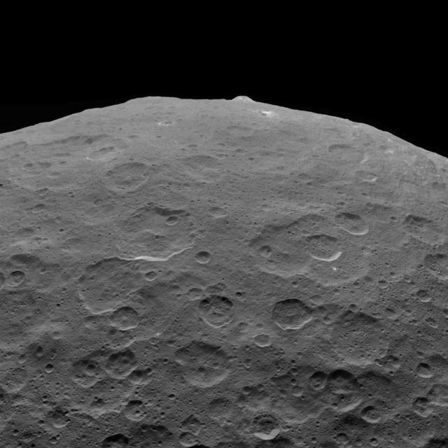 This photo of Ceres and one of its key landmarks, Ahuna Mons, was one of the last views Dawn transmitted before it depleted its remaining hydrazine and completed its mission.  This view, which faces south, was captured on Sept. 1, 2018 at an altitude of 2,220 miles (3,570 kilometers) as the spacecraft was ascending in its elliptical orbit. At its lowest point, the orbit dipped down to only about 22 miles (35 kilometers), which allowed Dawn to acquire very high-resolution images in this final phase of its mission. Some of the close-up images of Ceres are shown here.  Ahuna Mons is about 12 miles (20 kilometers) across and 2.5 miles (4 kilometers) high and displays sodium carbonate along its flanks. This is the most recent of a potential two dozen cryovolcanoes whose remnants are found across Ceres' surface.  https://photojournal.jpl.nasa.gov/catalog/PIA22769